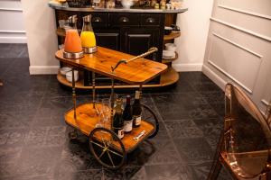 a bar cart with wine bottles and glasses on it at Le Mireille in Paris