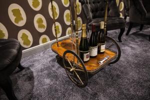 a cart with wine bottles and glasses on it at Le Mireille in Paris