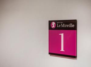 a sign that reads la mullella on a wall at Le Mireille in Paris