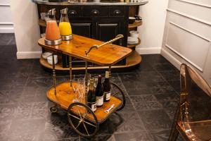 a cart with wine bottles and glasses on it at Le Mireille in Paris