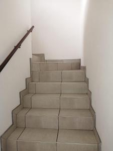 a set of stairs in a white room at Corona Del Mar 7 in Margate +10 photos