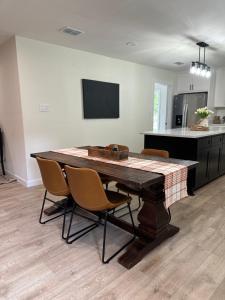 a kitchen with a table and chairs in a room at Hillside House Room 2 in Tyler