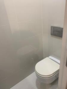 a bathroom with a white toilet in a stall at Casa Muralla in Ribadeo