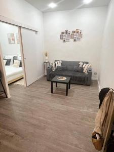 a living room with a couch and a coffee table at Appartement côté centre-ville in Marseille