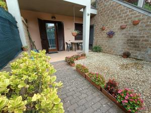 a house with a patio with flowers and a table at House 39 in Capranica