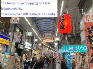 a group of people walking through a shopping mall at Private Japanese garden,130m2, Ikebukuro Shinjuku Shibuya 5-15min , 200 restaurants nearby, 7-11 in front in Tokyo