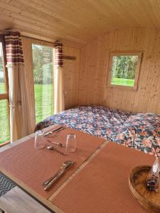 a room with a bed and a table with utensils on it at Gîte du moulin Baillot in Chessy-les-Prés