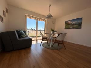 a living room with a table and a chair at Gmiatliches Eck in Eberfing