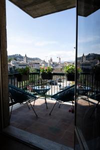 a balcony with chairs and a view of a city at CENTER BOUTIQUE HOME SUL FIUME in Ascoli Piceno