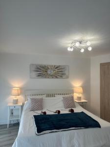 a bedroom with a white bed with flowers on it at T3Appartement de luxe Croisette en face de la plage Martinez 80m2 in Cannes