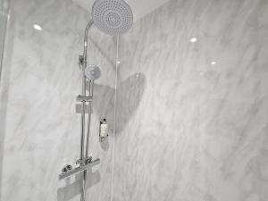 a shower with a shower head in a bathroom at INNit Marina in Brighton & Hove