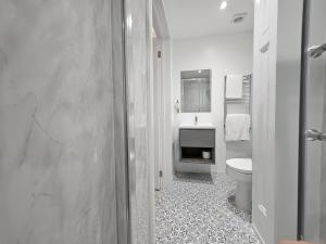 a white bathroom with a toilet and a sink at INNit Marina in Brighton & Hove +25 photos