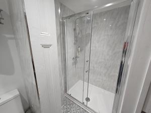 a shower with a glass door in a bathroom at INNit Marina in Brighton & Hove