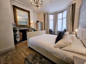 a bedroom with a bed with a fireplace and a mirror at INNit Marina in Brighton & Hove