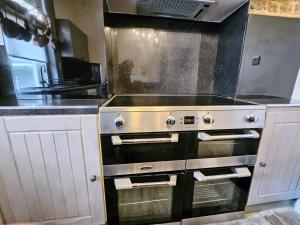 a kitchen with a stove top oven in a kitchen at INNit Marina in Brighton & Hove