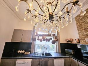 a kitchen with a chandelier hanging from a ceiling at INNit Marina in Brighton & Hove