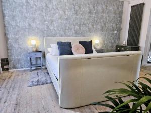 a bedroom with a white bed with two night stands at INNit Marina in Brighton & Hove