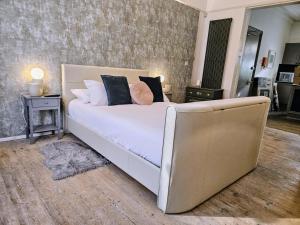 a bedroom with a large bed and a couch at INNit Marina in Brighton & Hove