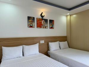 Postel nebo postele na pokoji v ubytování Thanh Hiền HB Hotel