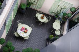 an overhead view of a patio with tables and chairs at Le Mireille in Paris