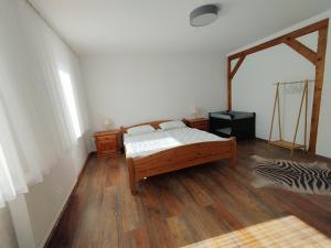 a bedroom with a bed and a wooden floor at Haus am Wald Zorge 16+ Gäste in Walkenried
