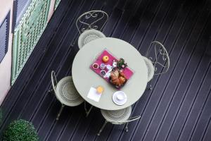 a plate of food on a table on a balcony at Le Mireille in Paris