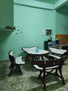a room with tables and chairs in a kitchen at No 25 by SaamSaao HomeStay Betong - 4 Bedroom in Betong