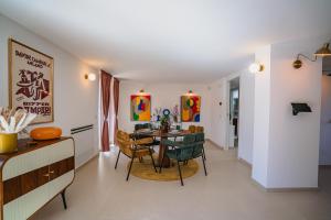 a dining room and living room with a table and chairs at Bitter 26 Apartment - Vinto House Collections in Nocera Superiore +42 photos