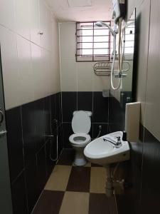 a bathroom with a toilet and a sink at Casavilla Hotel in Taiping