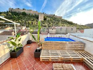 a rooftop patio with a pool on a roof at Casa con jacuzzi y piscina con vistas al castillo in Corbera de Alcira
