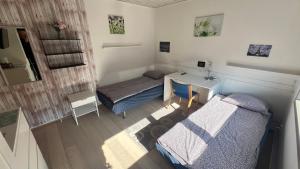 A bed or beds in a room at Pavillon Greve