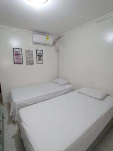 Postel nebo postele na pokoji v ubytování Hostal Miami Beach