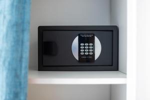 a remote control sitting on top of a shelf at Best Western Hôtel Royan Océan in Royan