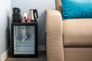 a side table with bottles of water and a couch at Best Western Hôtel Royan Océan in Royan