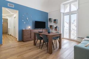 a living room with a table and a tv at Casa Bonetti in Ascoli Satriano