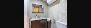 a bathroom with a sink and a mirror and a tub at Rural-ya Alojamientos Granada Nevada home in La Zubia