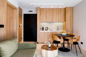 a living room with a table and a kitchen at Apartament Wood Design ED73341 in Białka Tatrzańska