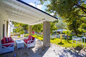 a pavilion with chairs and tables on a patio at Berat River House Boutique Hotel in Berat