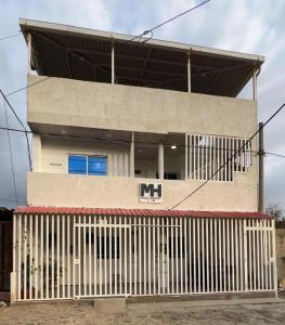 a building with a fence in front of it at Magic horizont in Taganga