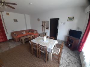 a living room with a table and a couch at Apartment Kolonija in Slavonski Brod +12 photos