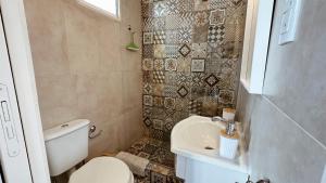 a small bathroom with a toilet and a sink at Casa Miriam - Casa En Miramar Para 4 PAX Con Cochera - Hola Sur in Miramar +11 photos