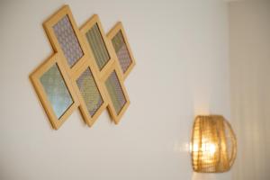 a wall with three wooden crosses on it at Villa Petite Fleur proche Paris CDG Disney Astérix et Parc des Expos in Villeparisis