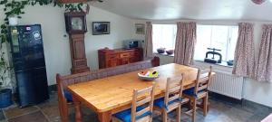 a dining room with a wooden table and chairs at Hill House in Banbury