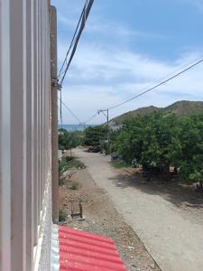 a red and white flag on the side of a building at Magic horizont in Taganga +1 photo