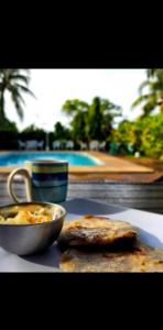 a table with a bowl of food and a plate of food at Jaco Mizata Beach and River in Las Piedras +18 photos