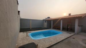 a swimming pool on the patio of a house at Casa família Mota in Brotas