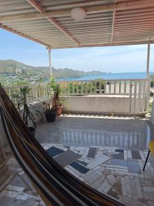 a hammock on a patio with a view of the ocean at Magic horizont in Taganga