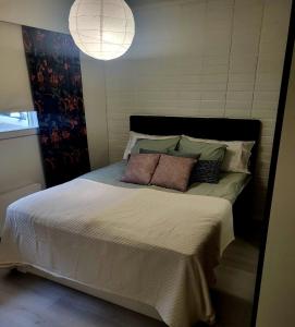 Un dormitorio con una cama con dos almohadas encima. en Tilava uudistettu perheasunto, en Rovaniemi