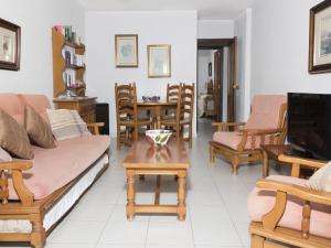a living room with a couch and chairs and a tv at Apartamentos Turmalina Unitursa in Calpe