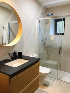 a bathroom with a sink and a shower with a mirror at La Casita 3 dormitorios in Santillana del Mar